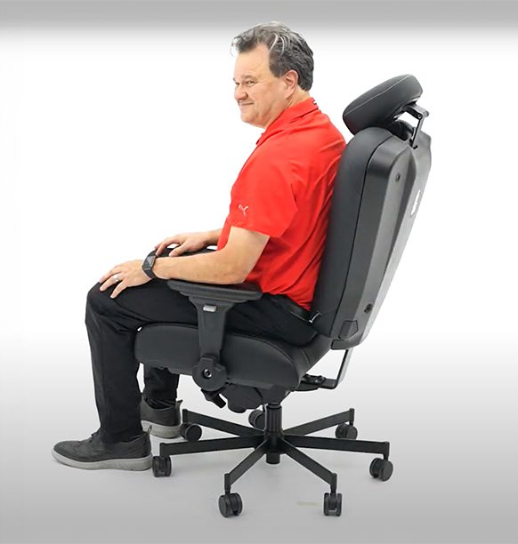 a man sitting happily on a concept seating chair