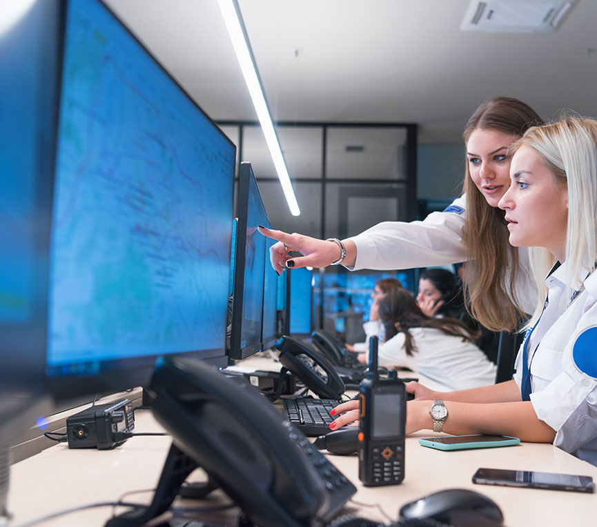 Two security officers working at a computer