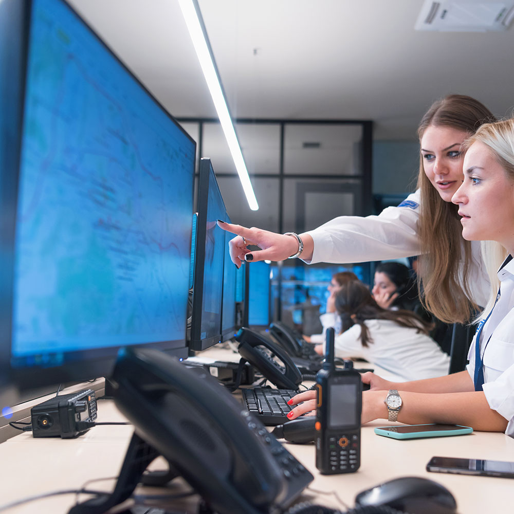 Two security officers working at a computer